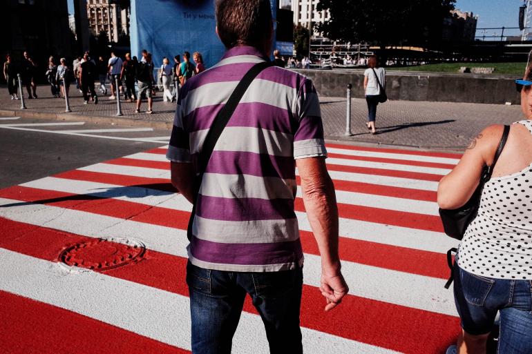 Gestreift! Auf den Straßen von Kiew entdeckte Jonas Grauel 2021 diese Szene. Bewusst konzentrierte er den Bildausschnitt auf die Dopplung der Querstreifen – auf der Straße und auf dem T-Shirt. Kiew | Ricoh GR | 18 mm | 1/3200 s | f/8 | ISO 800